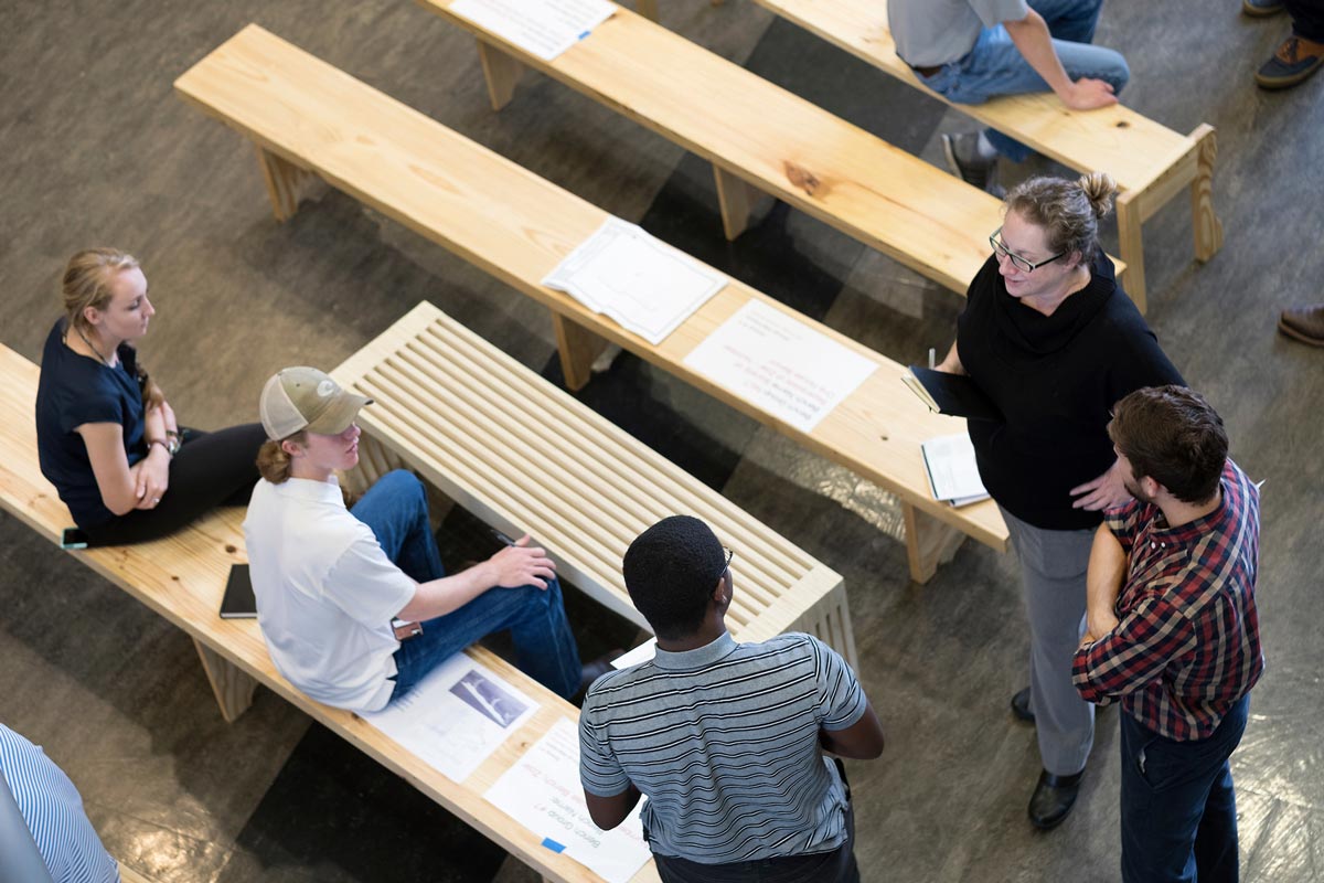 Collaboritive Studios: Students sitting on benches.