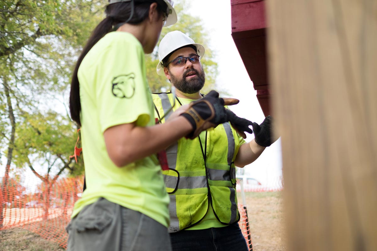 Students discussing construction of building