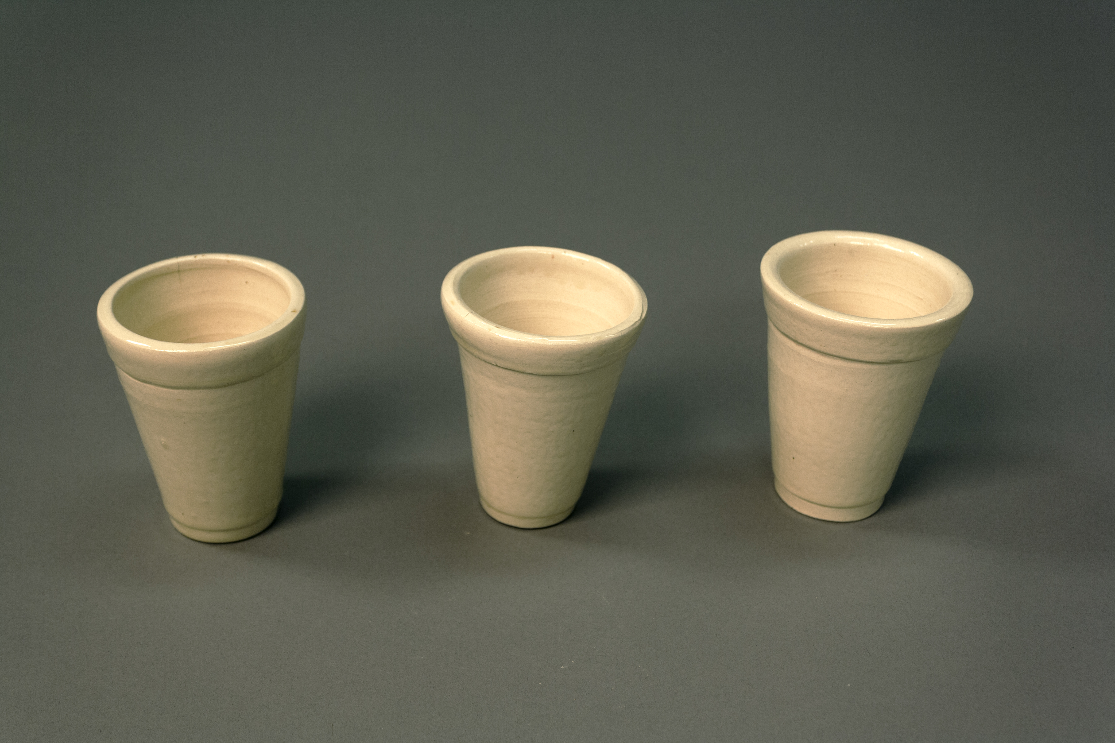 3 ceramic cups that are in the form of a styrofoam cup. 