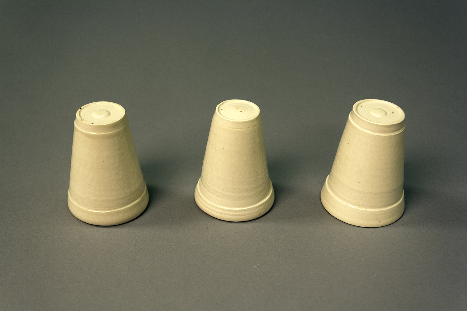 3 styrofoam cups made of ceramics, upside down
