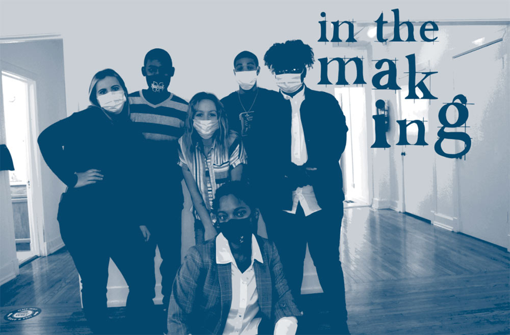students pose wearing mask in front of "in the making" sign for their senior exhibit