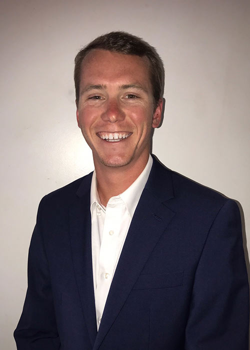 Jamison McKee headshot - white background - wearing suit