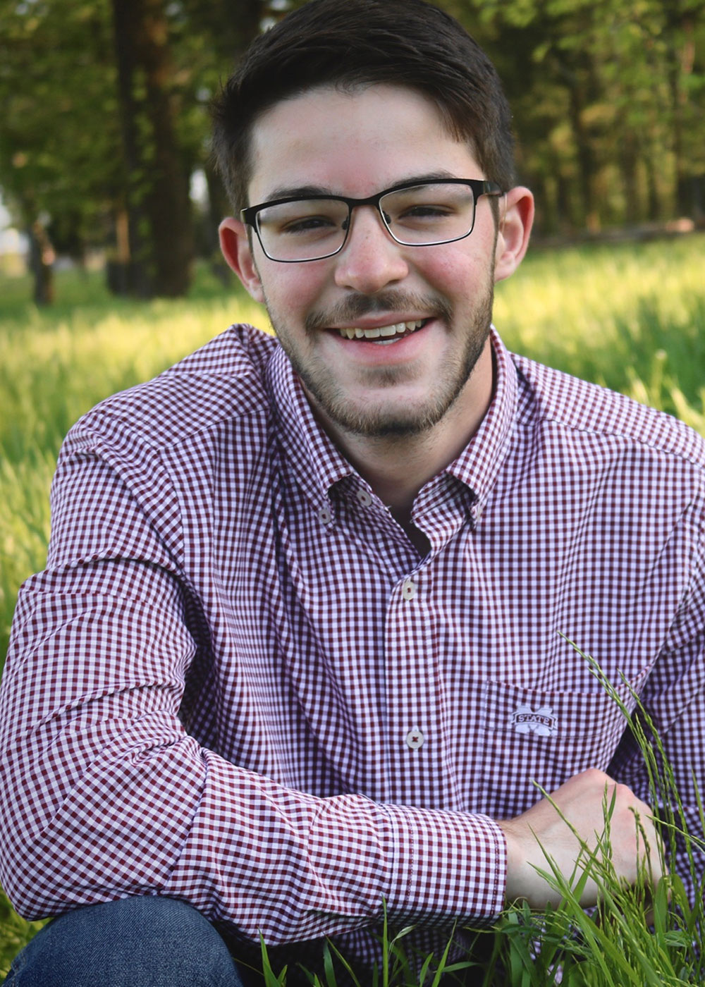 Elijah Rietz poses in grass