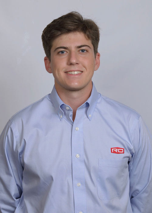 Christopher “Chris” Sharp headshot - wearing light blue dress shirt, light background