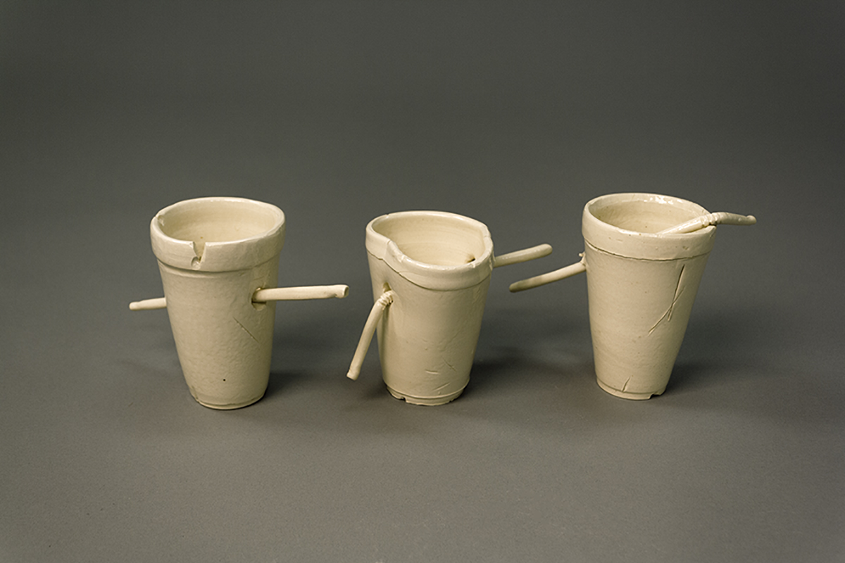 ceramic cups as styrofoam cup with straws punctured through them. 