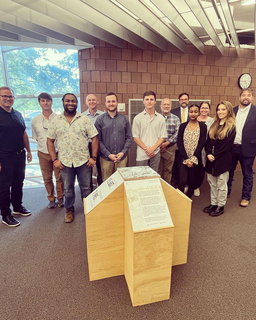 students and competition winners gathered for photo in the Charlotte and Richard McNeel Gallery in Giles Hall, Mississippi State University